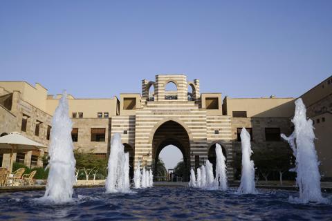 A big building with a fountain in front of it