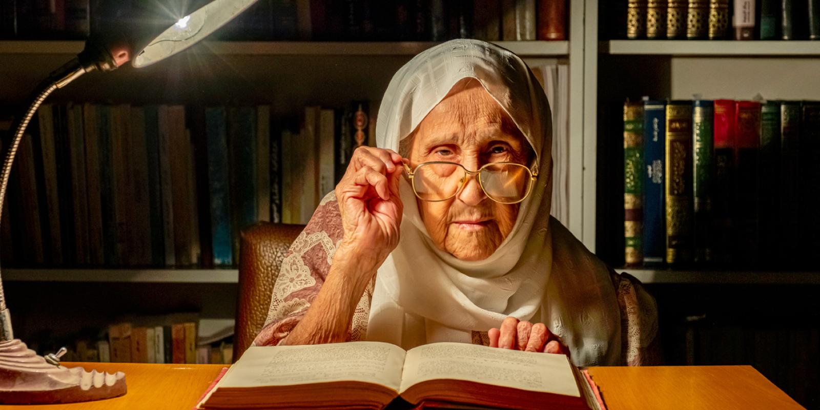 src image of old lady reading a book