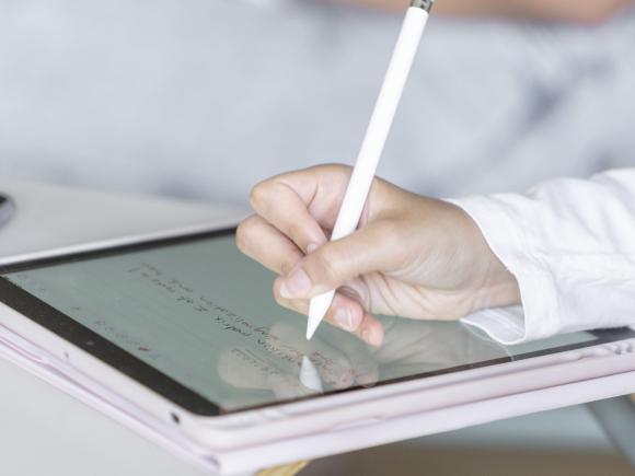 Hand writing on a tablet