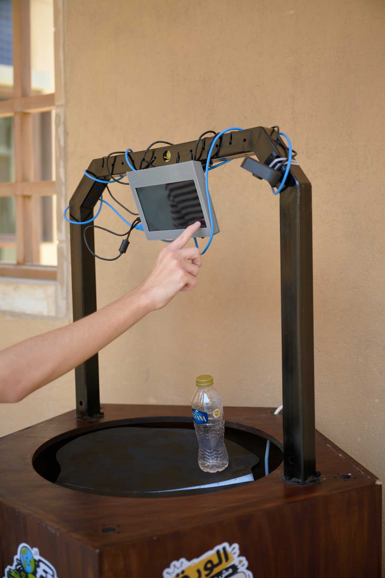 Operating the smart bin to clean plastic water bottle.