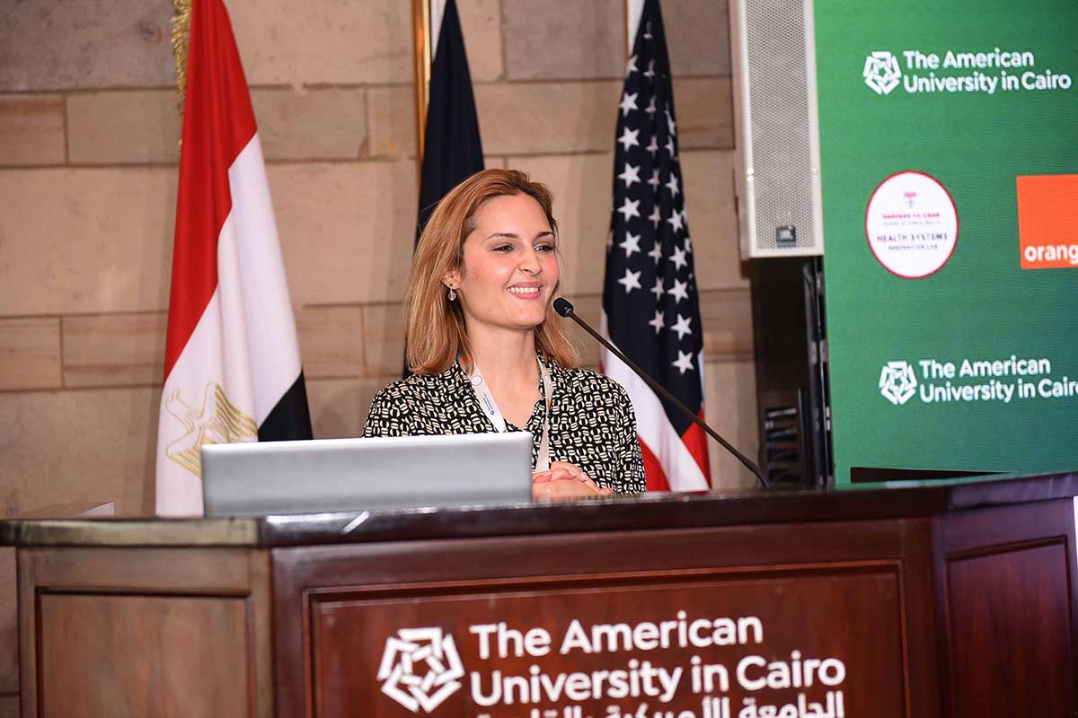 Seham Elmrayed speaks at a podium