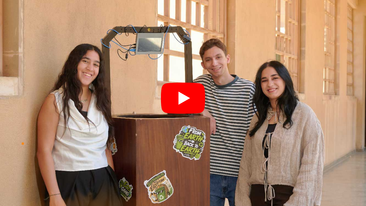Three students stand in front of the smart bin.