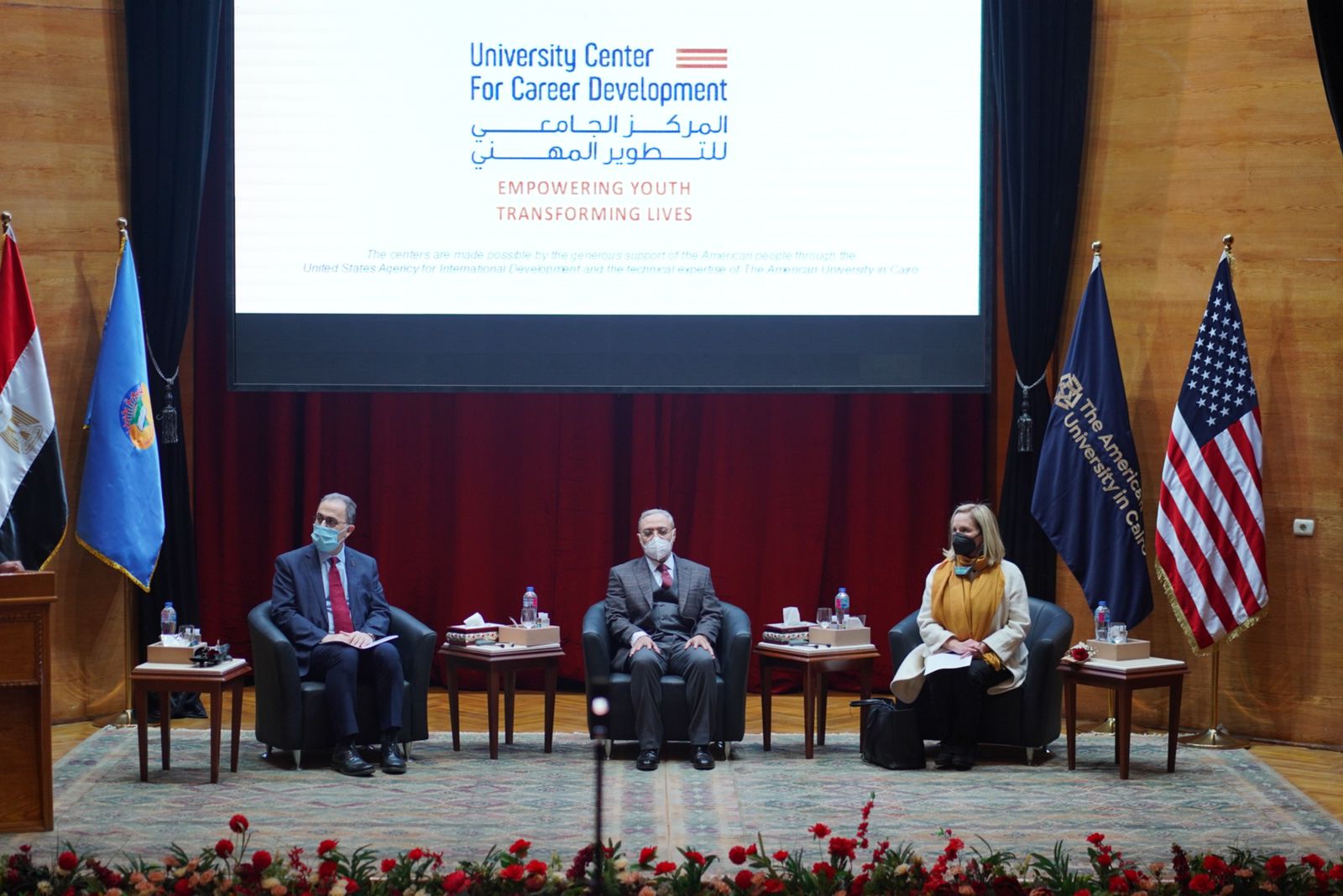 People sitting on stage at the event