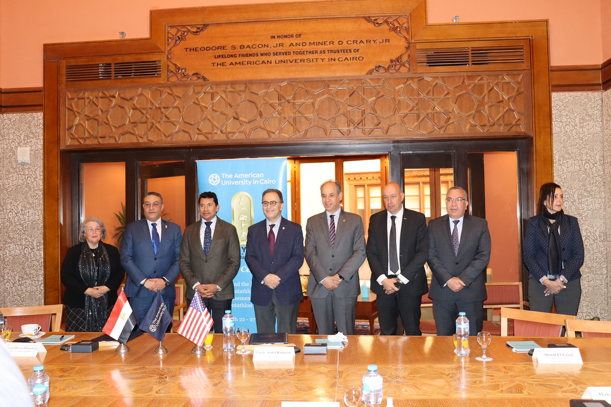 Group photo of men and a woman smiling