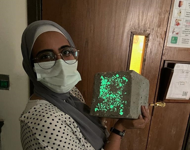 Student holding glowing concrete