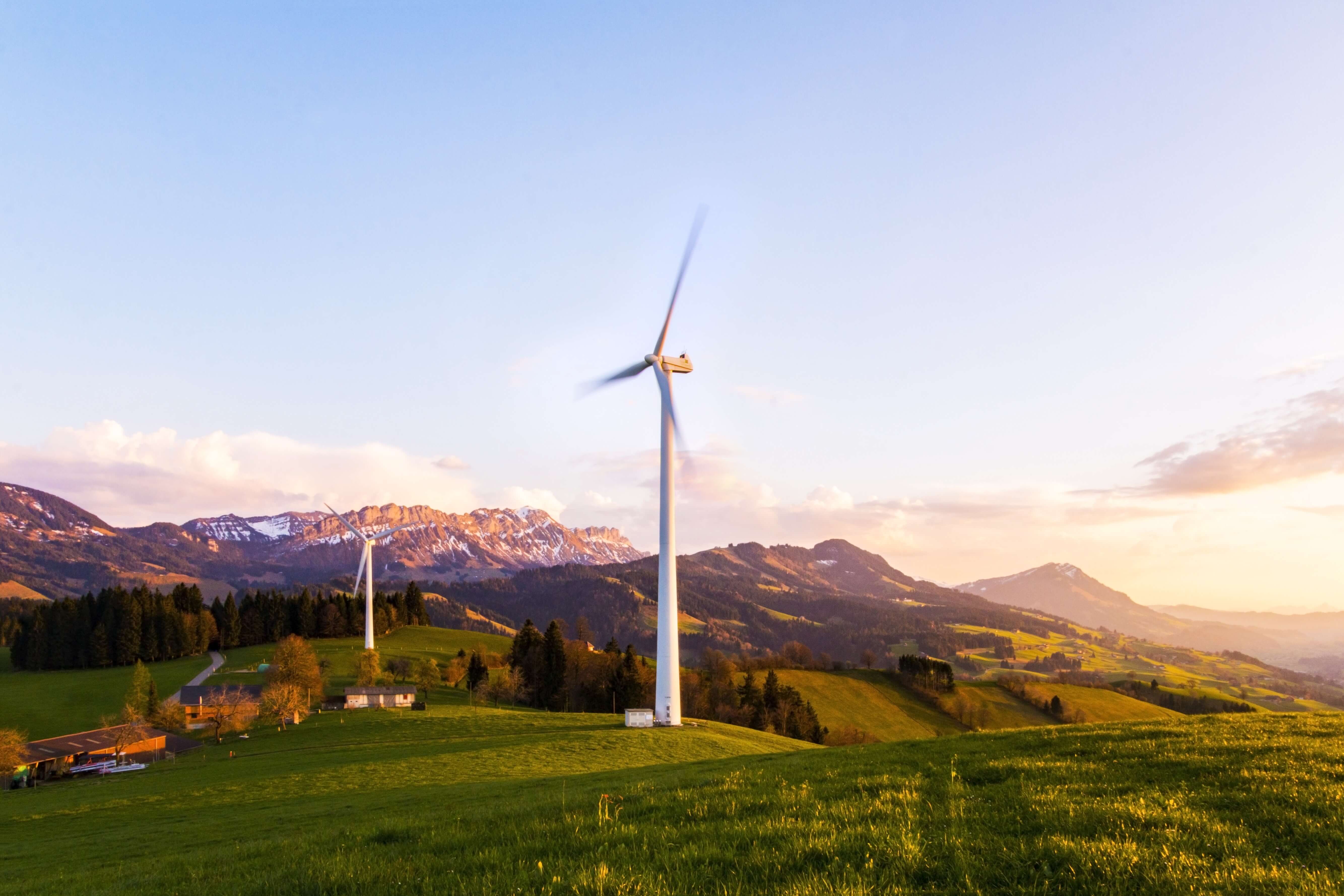 Windmills, mountains, trees, houses, greenery to represent energy transition for climate change