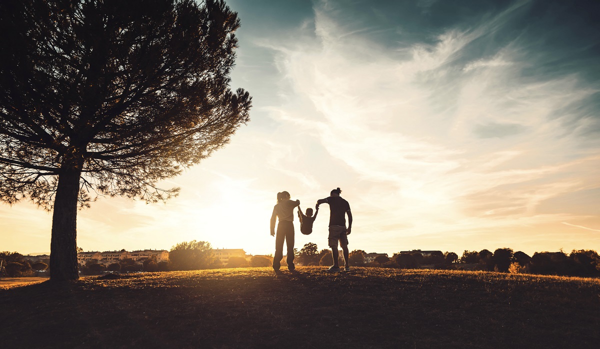 Silhouette of man, woman and child, and a tree representing public health in climate change