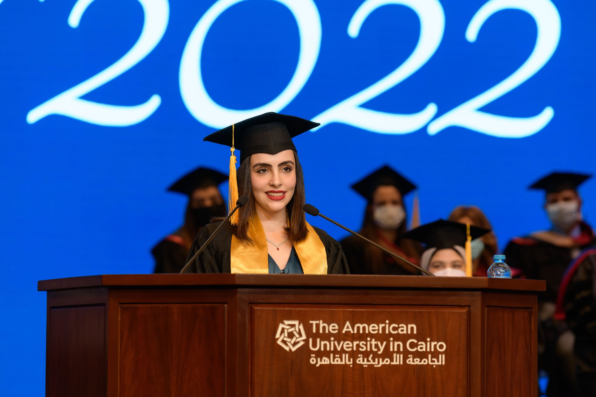 Graduate girl talking on podium