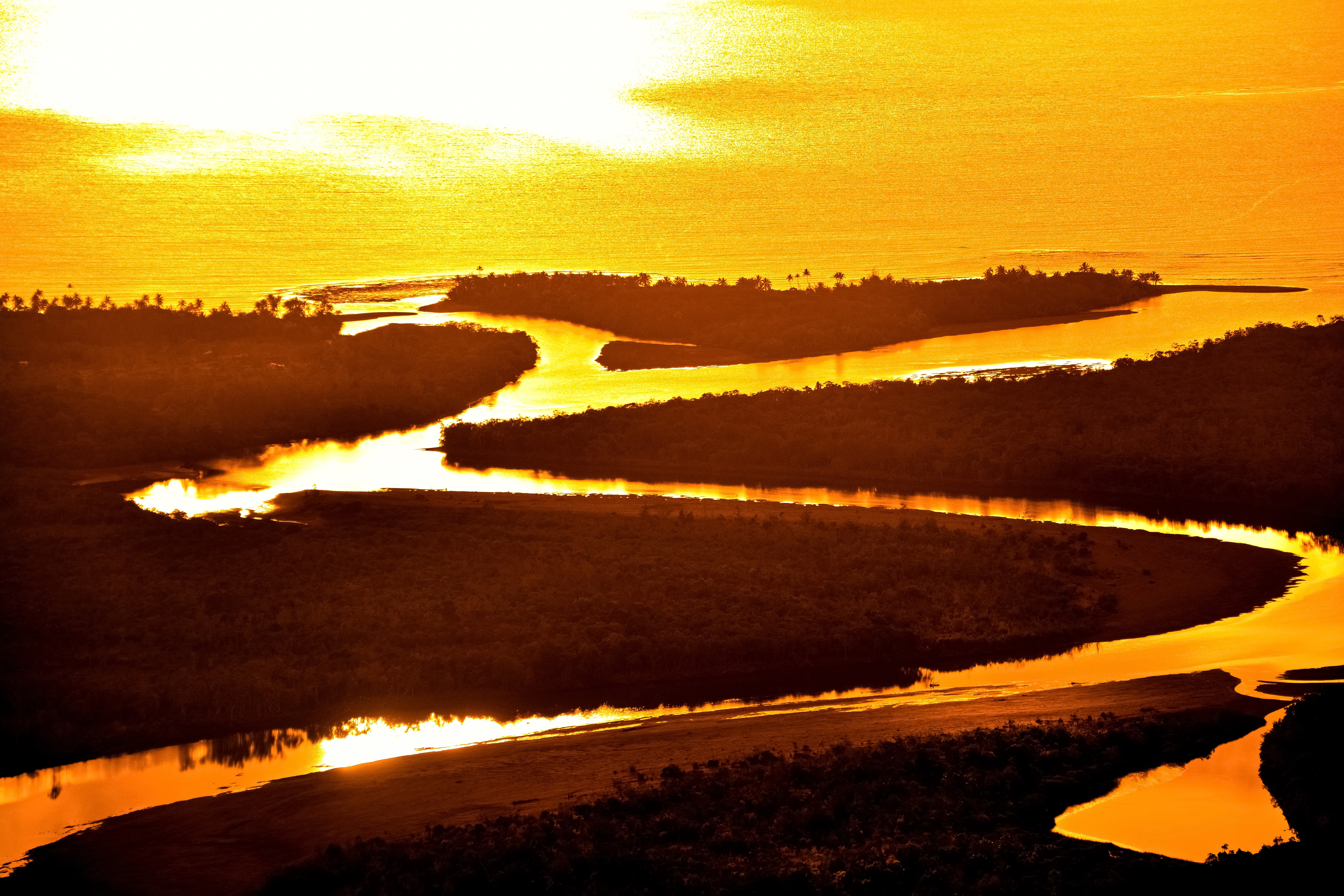 Sun shining over a river, representing global warming and climate change