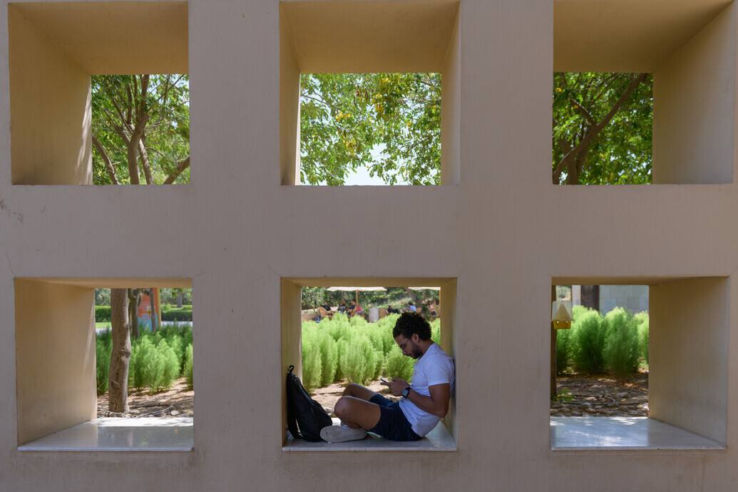 student studying in library stairs