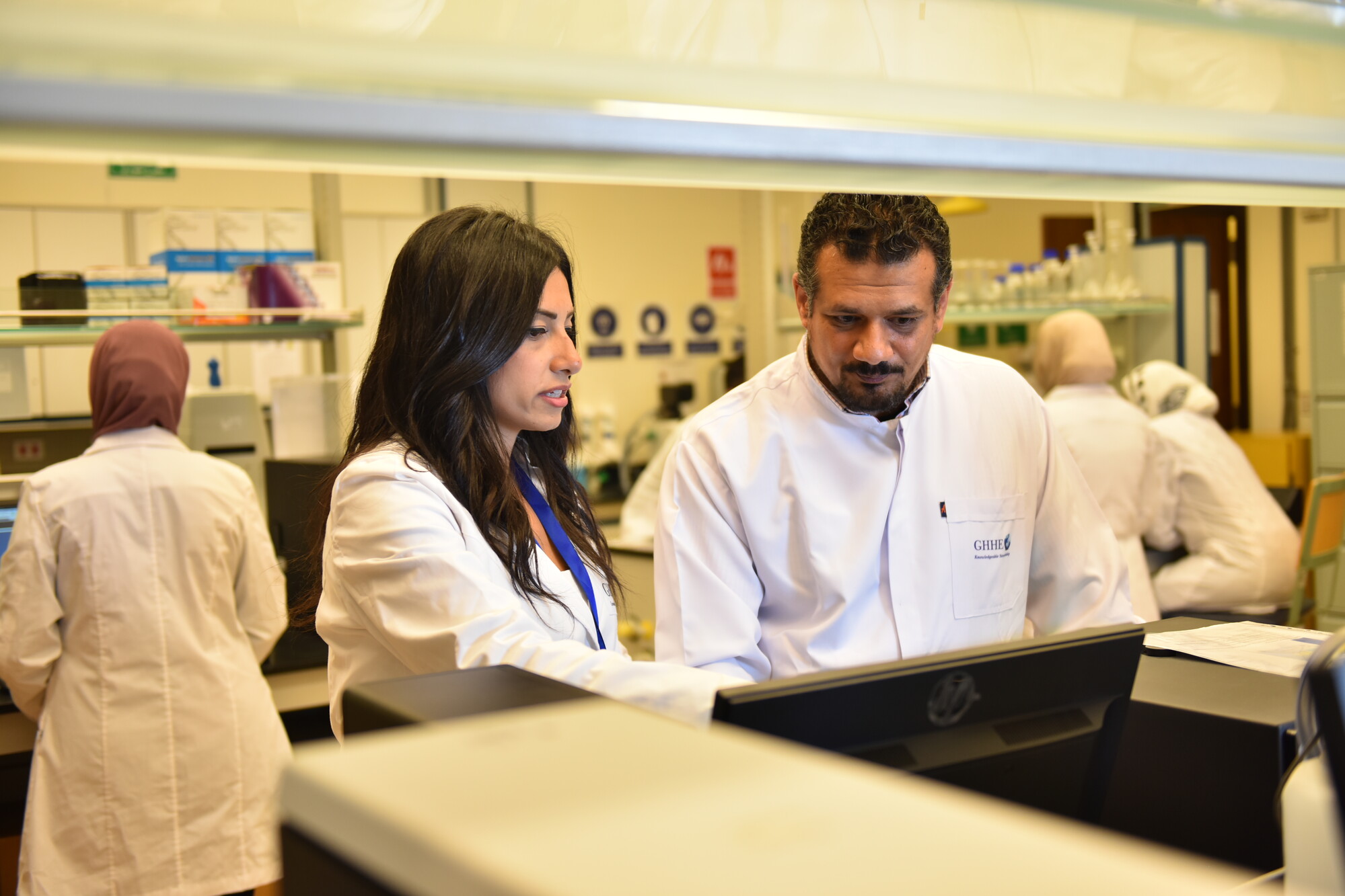 women and man doing research in a lab