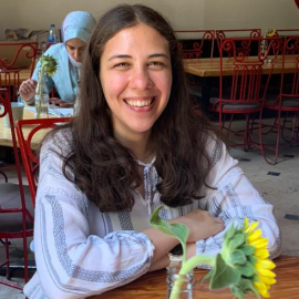Girl sitting on a table smiling
