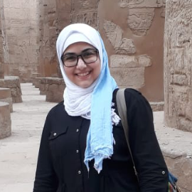 Veiled girl wearing glasses smiling