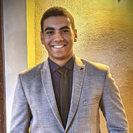 Boy wearing suit and tie smiling