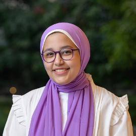 Veiled girl with glasses smiling