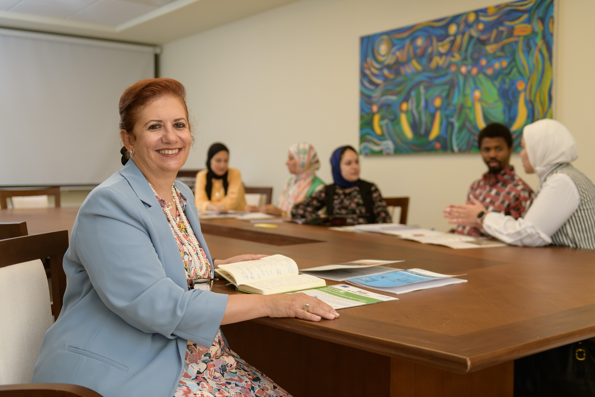 People in class and a woman smiling