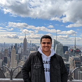 Boy smiling with skyscrapers in the background