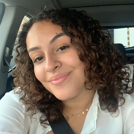 girl with curly hair smiling