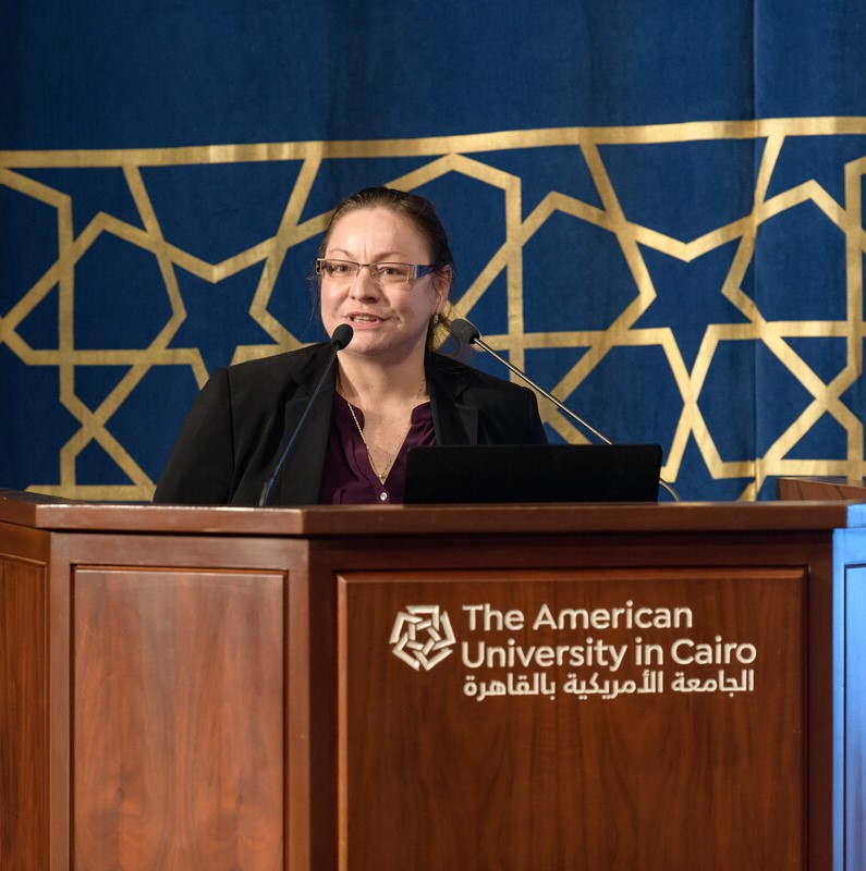 Lady on podium talking in microphone