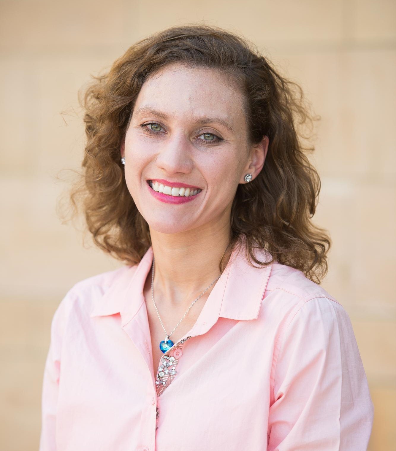 Lady wearing pink shirt smiling