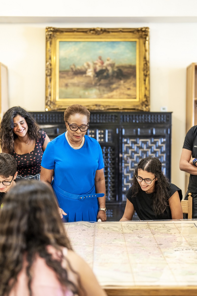 Professor and students looking at a map