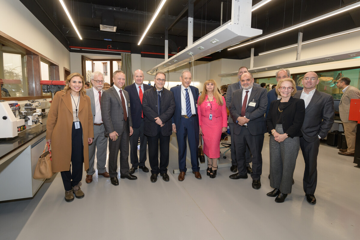 The Board of Trustees, faculty and staff visit Eltoukhy Learning Factory, pose in a line in front of lab equipment