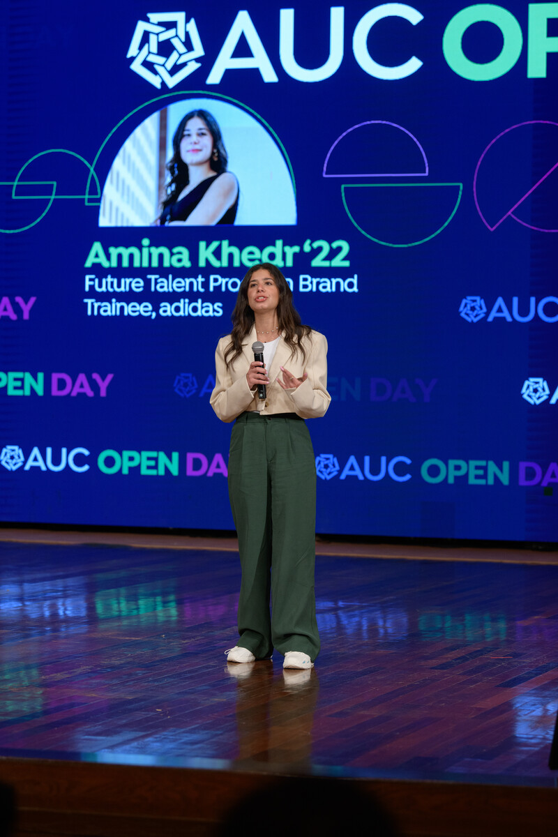 A girl talking on stage, AUC Open Day