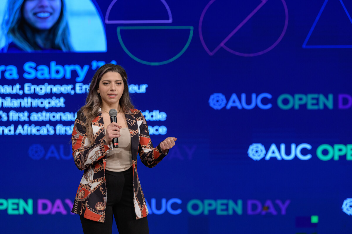 A girl talking on stage, AUC Open Day