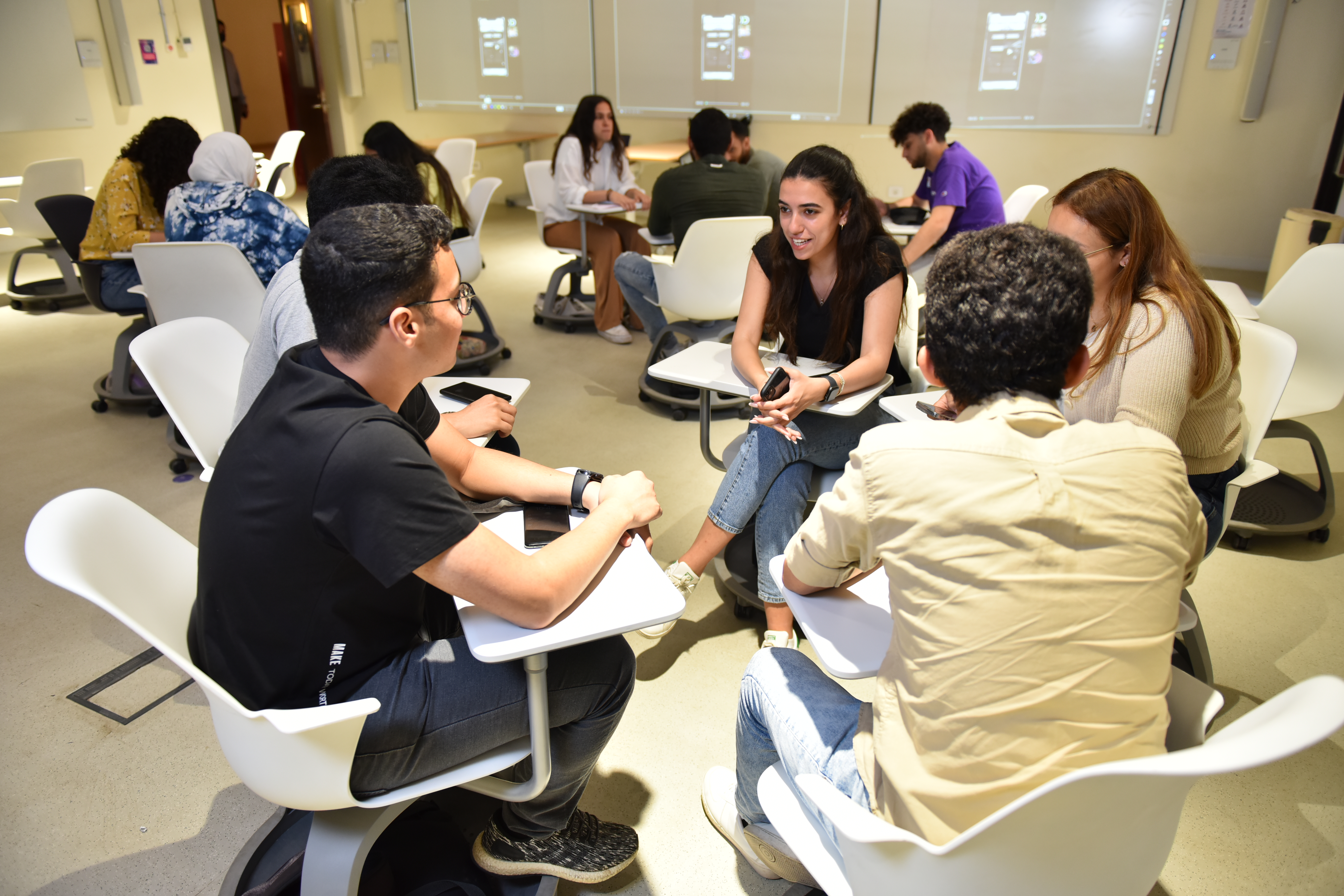 students working in a group in classroom having a group discussion