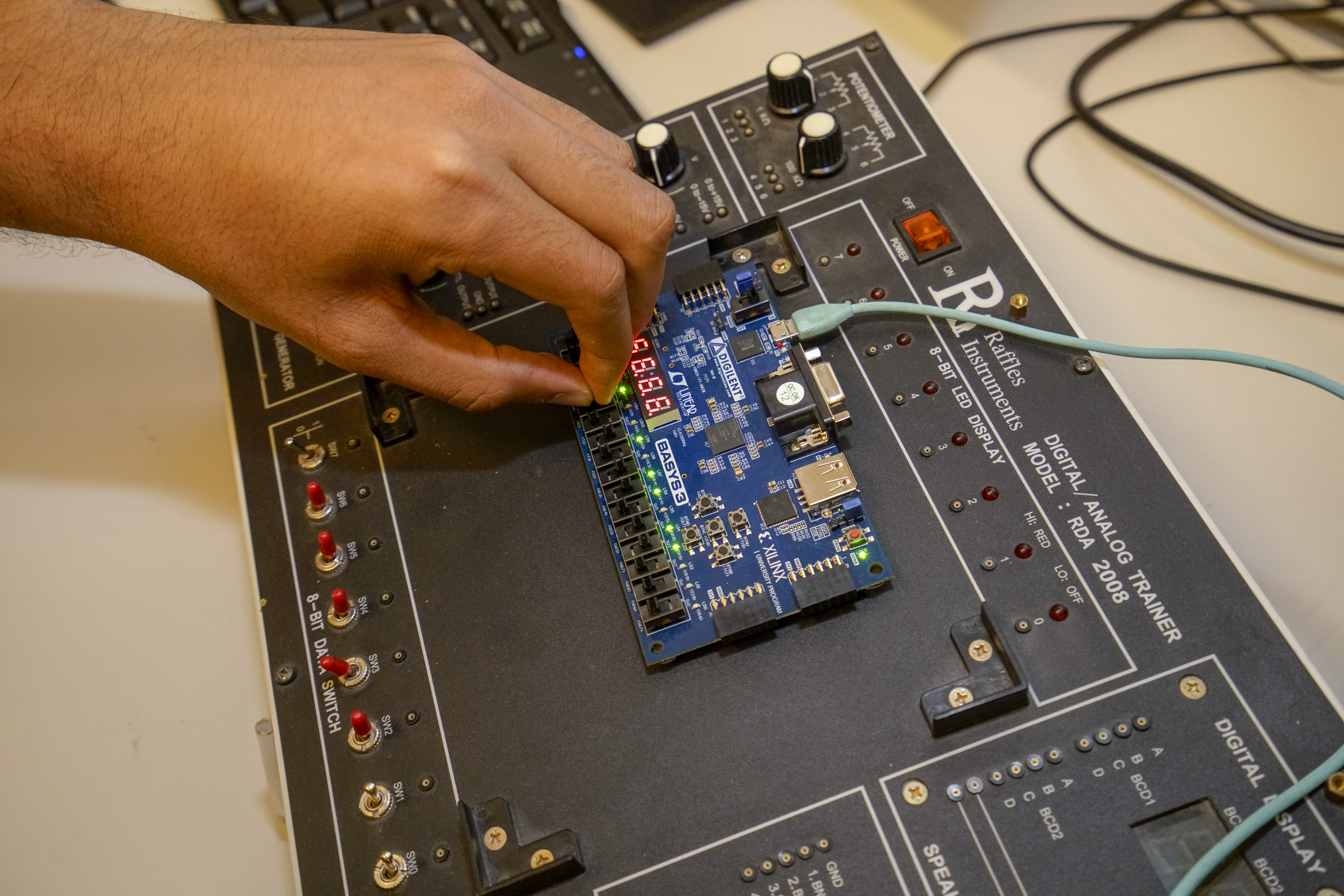 close up on student hand working with electrical board 