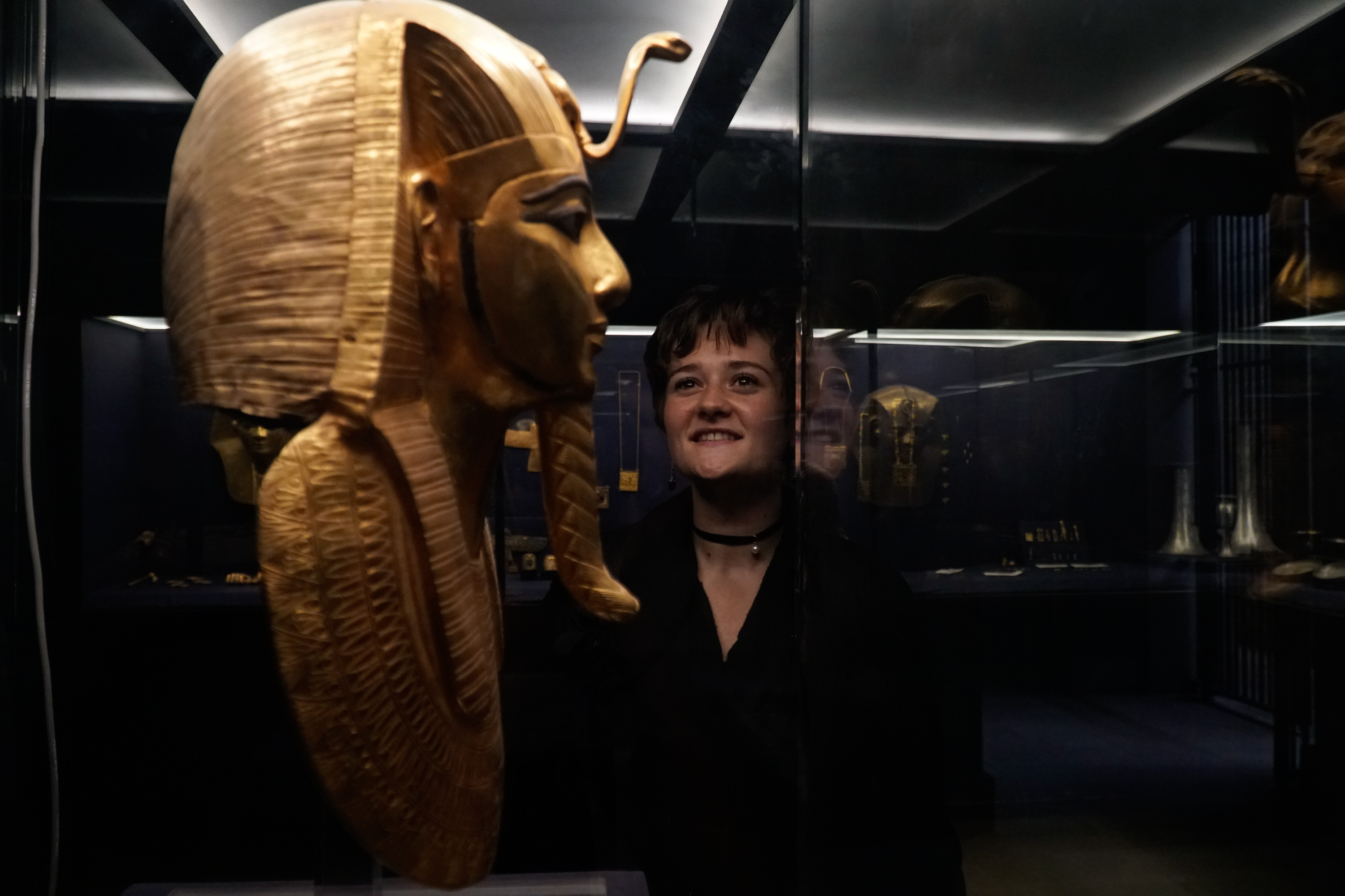 Students viewing ancient Egypt artifacts in museum 