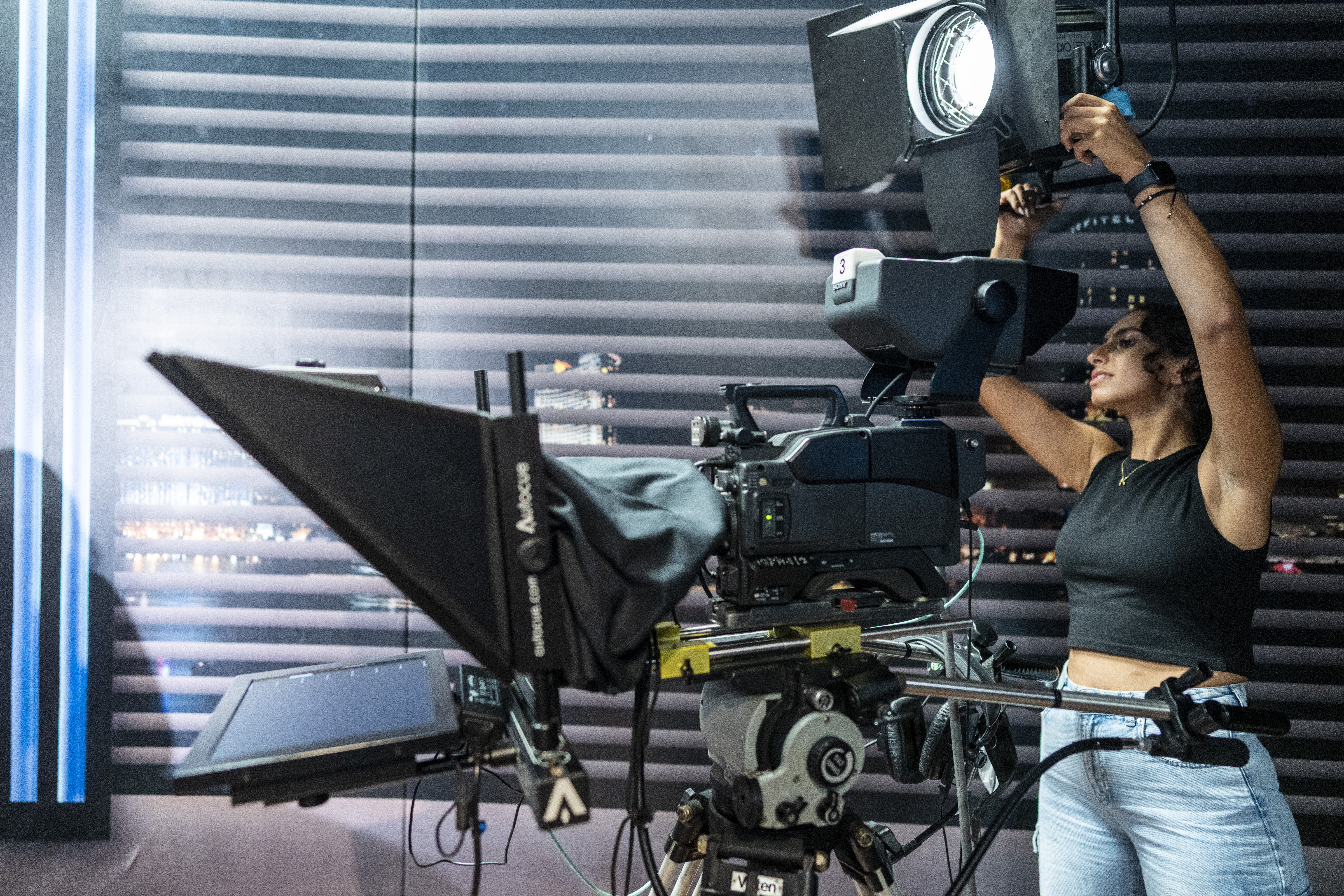 student working with camera and lighting in studio
