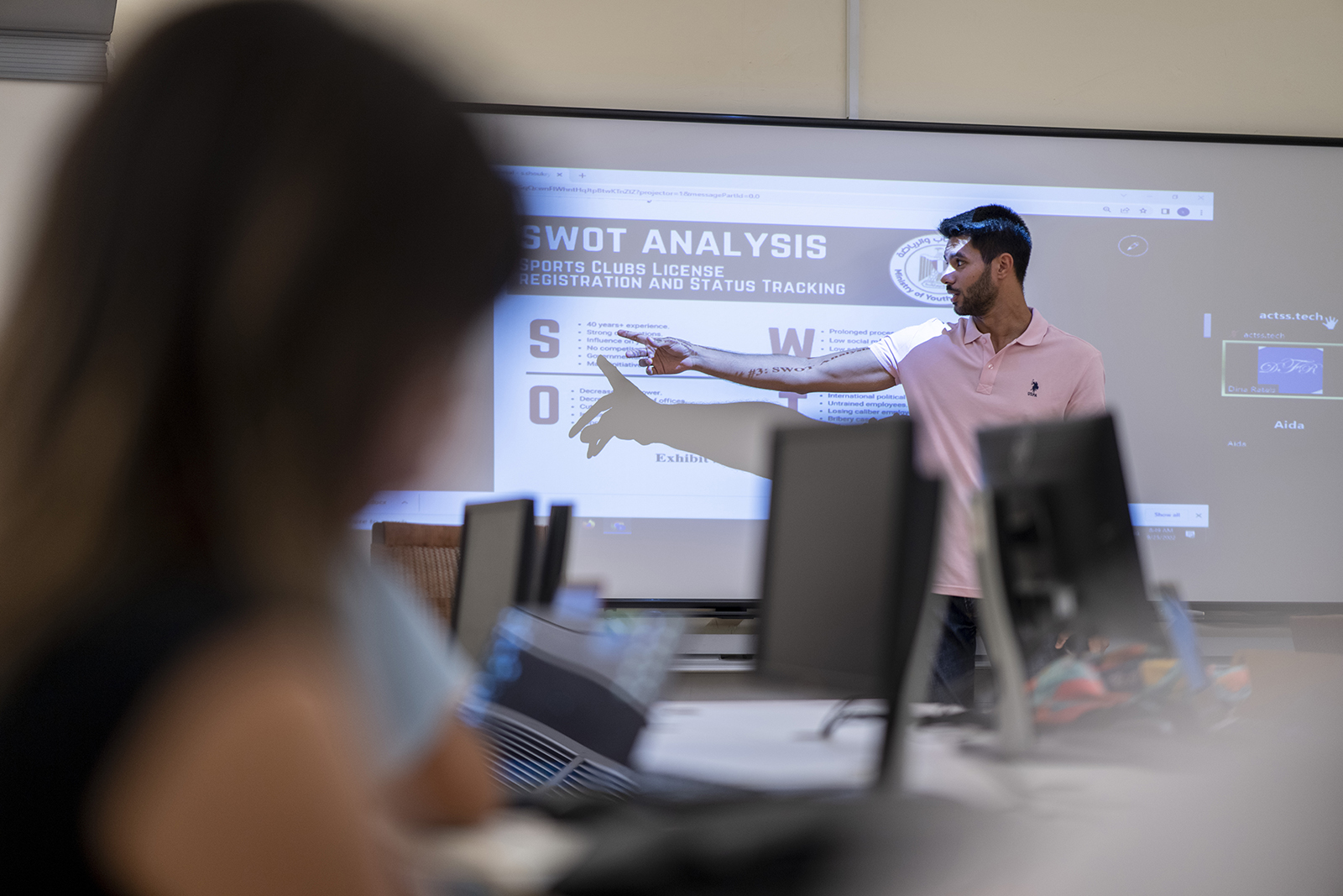 student making a presentation in classroom in front of classmates