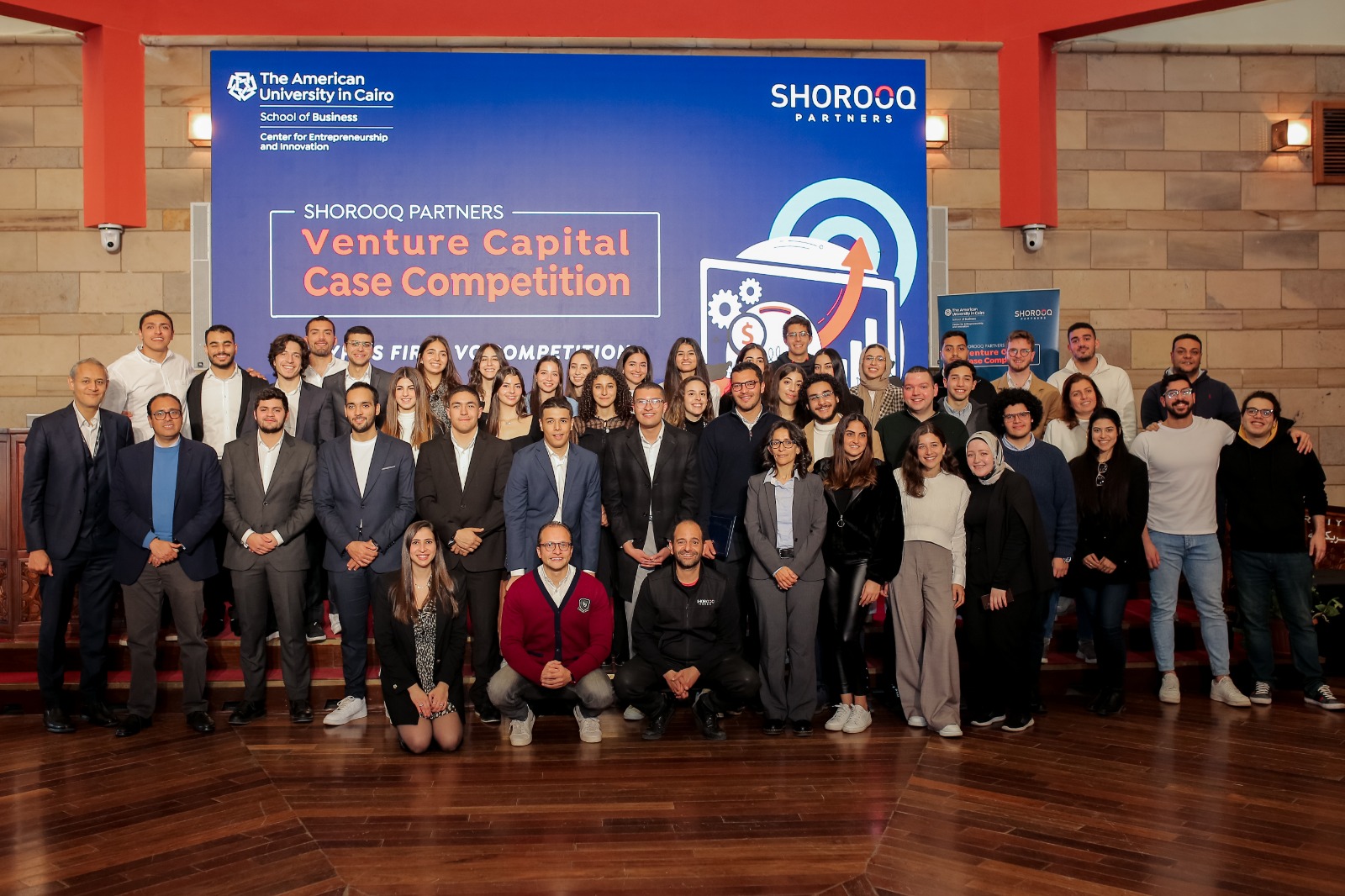 people stand on stage at the Venture Capital Competition