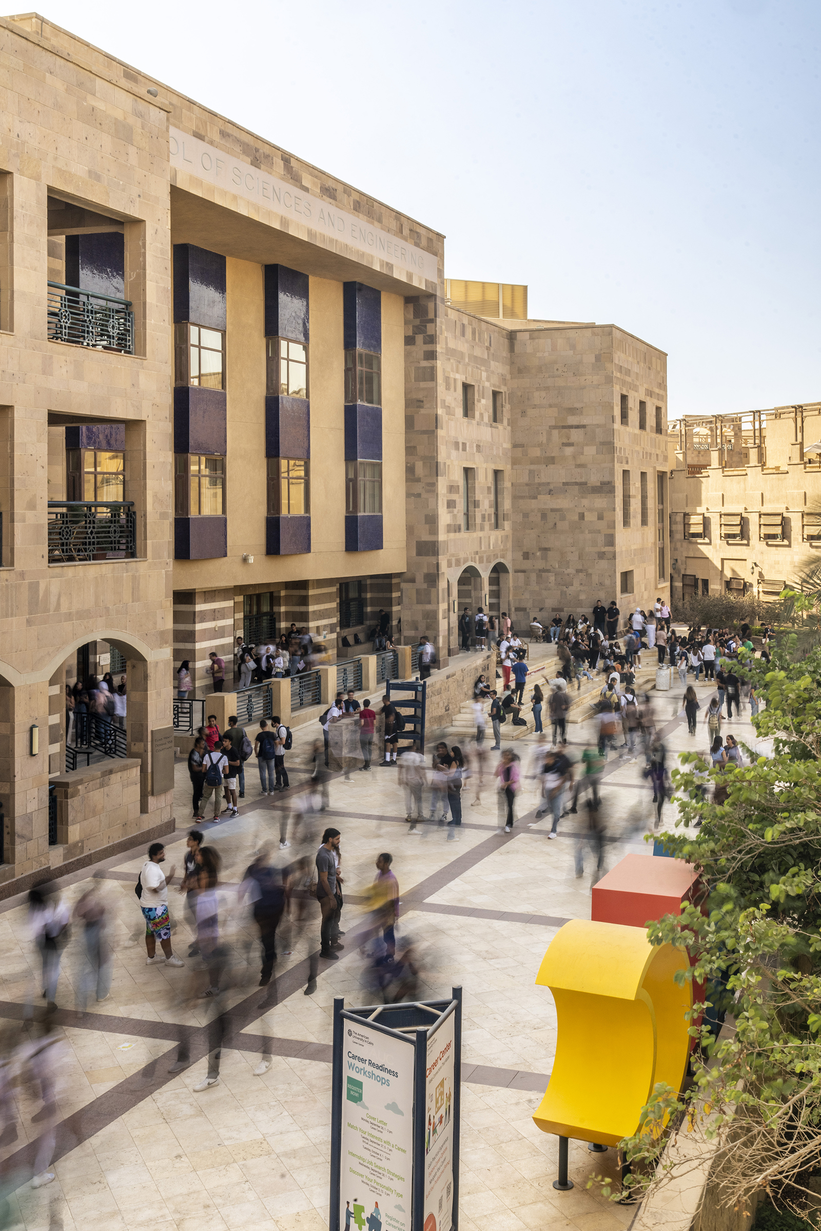 students on campus in front of sciences and engineering building