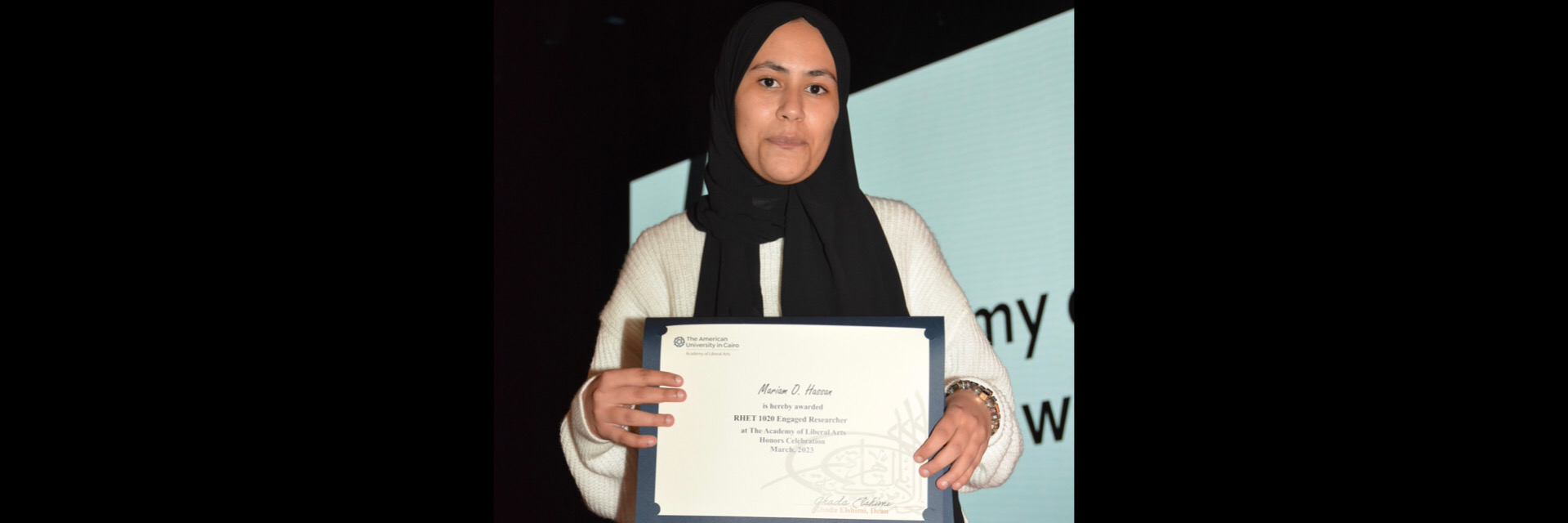 A picture of a student with their certificate of excellence 