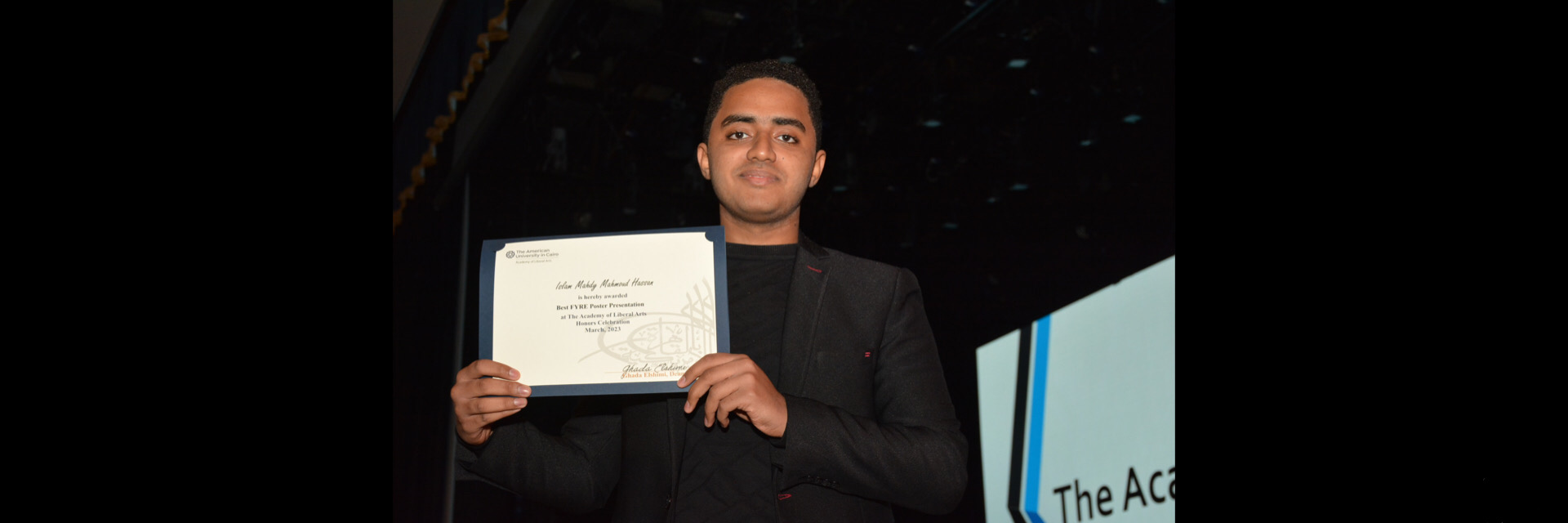 A picture of a student with their certificate of excellence 