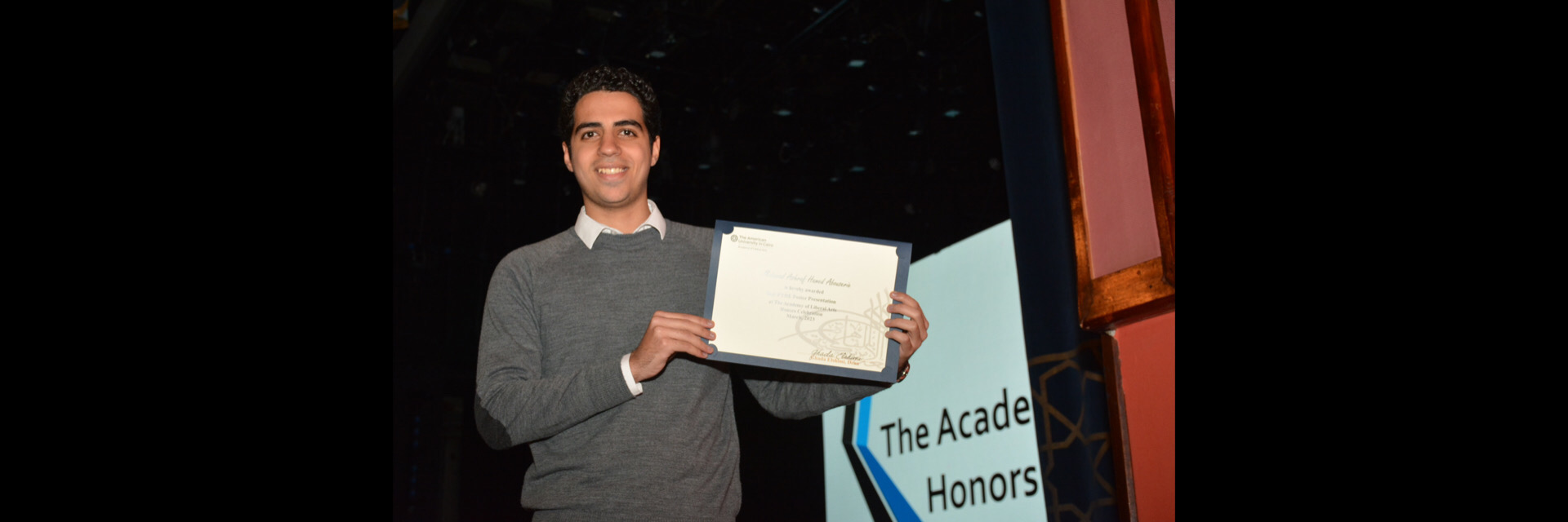 A picture of a student with their certificate of excellence 