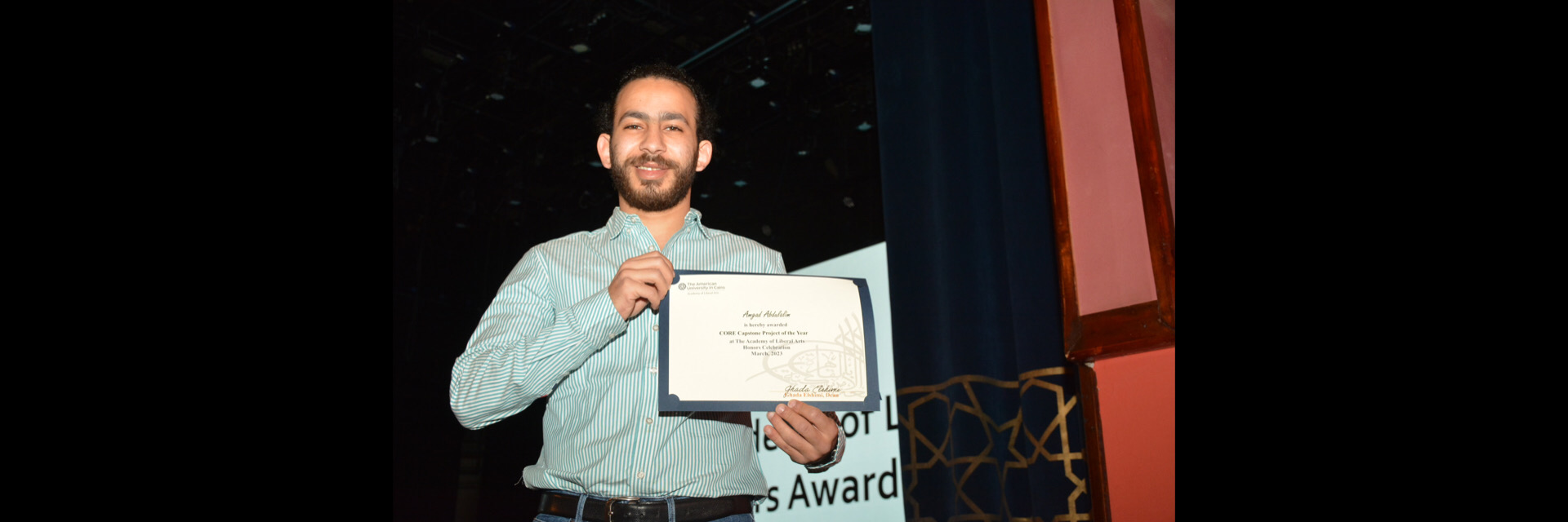 A picture of a student with their certificate of excellence 