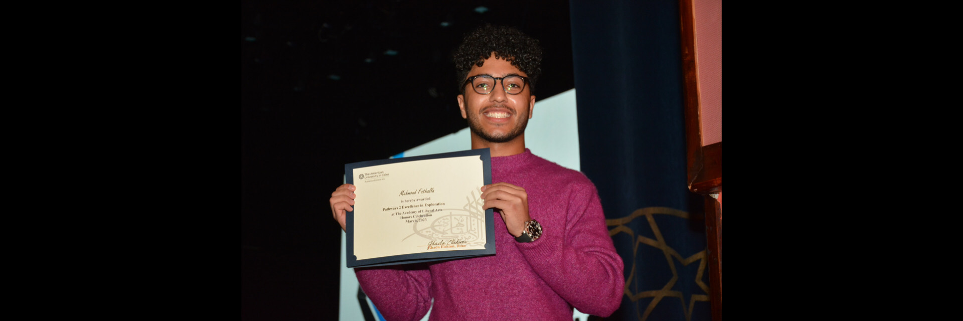 A picture of a student with their certificate of excellence 