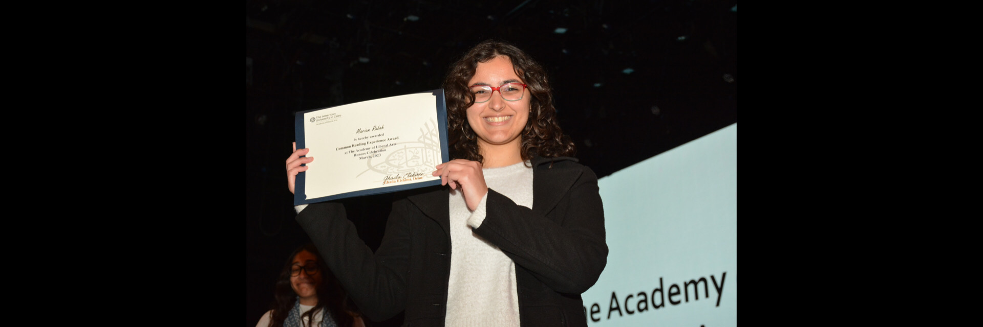 A picture of a student with their certificate of excellence 