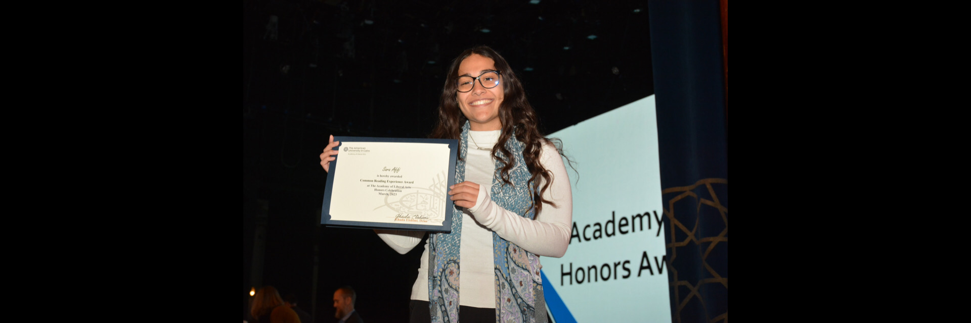 A picture of a student with their certificate of excellence 