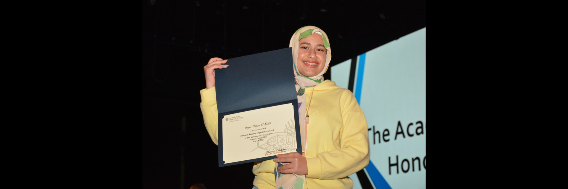 A picture of a student with their certificate of excellence 