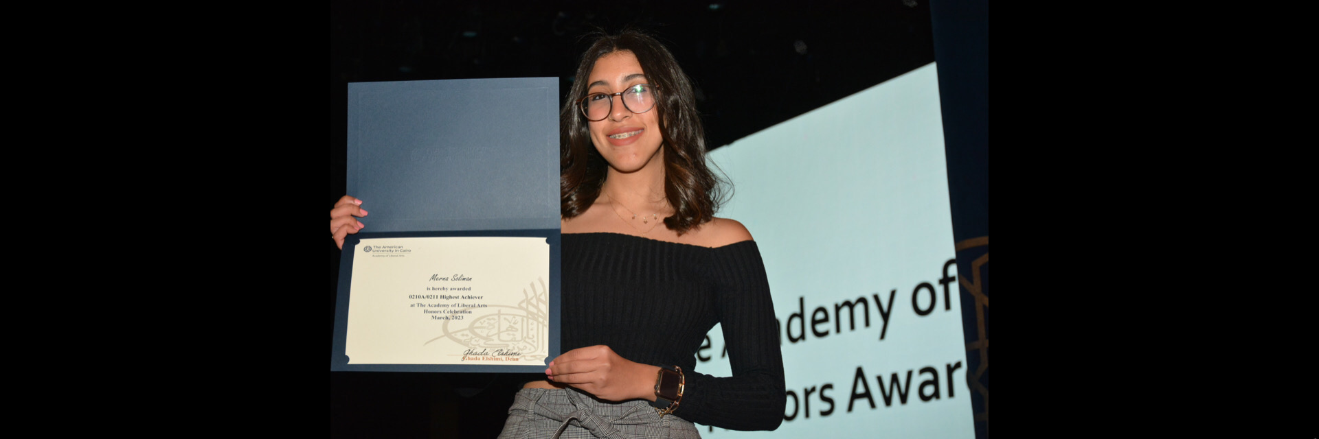 A picture of a student with their certificate of excellence 