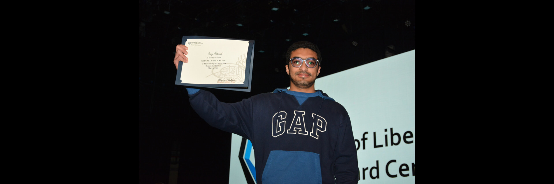 A picture of a student with their certificate of excellence 