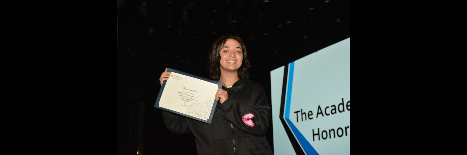 A picture of a student with their certificate of excellence 