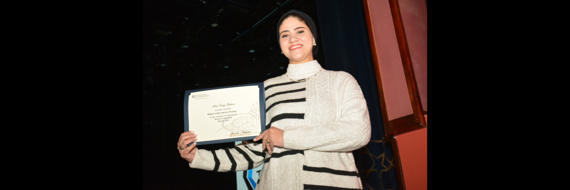 A picture of a student with their certificate of excellence 