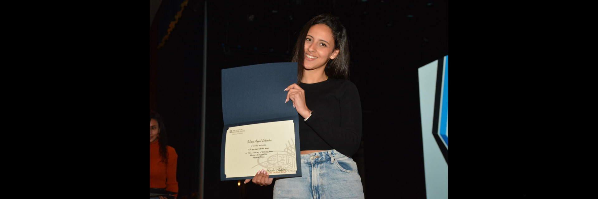 A picture of a student with their certificate of excellence 