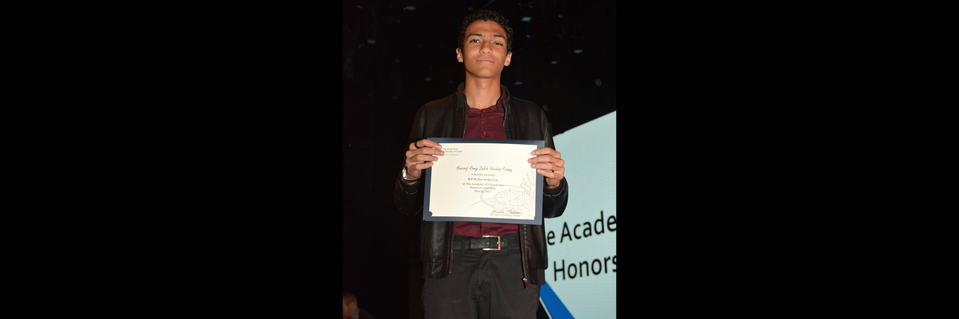 A picture of a student with their certificate of excellence 