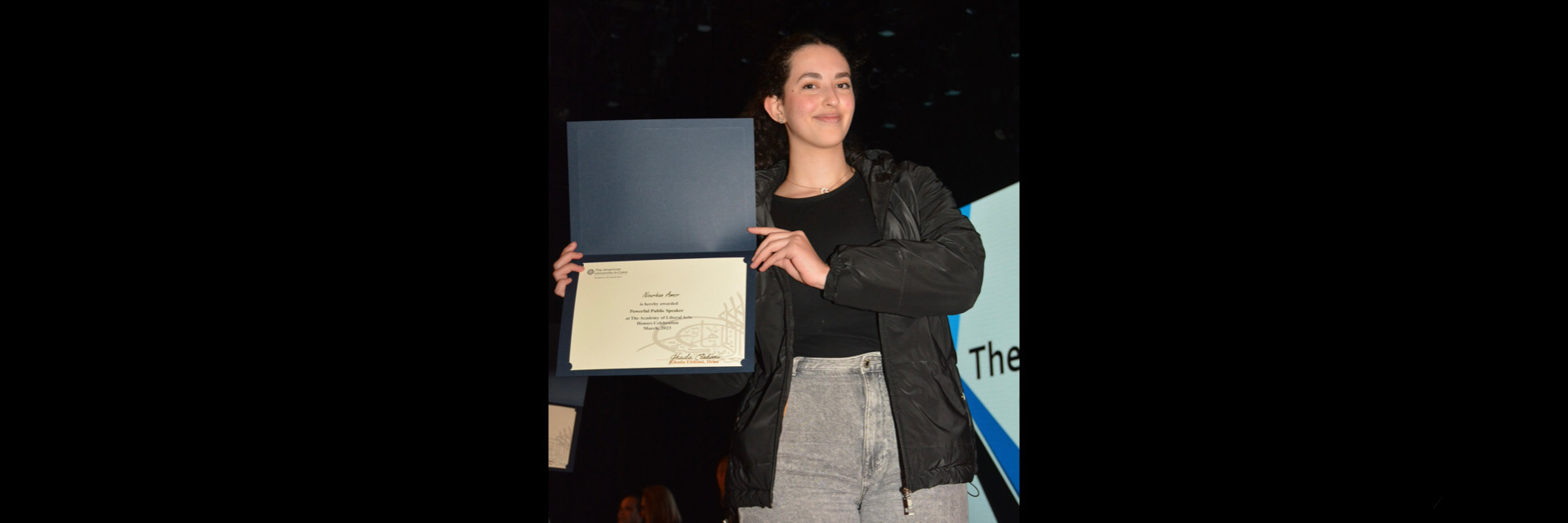 A picture of a student with their certificate of excellence 